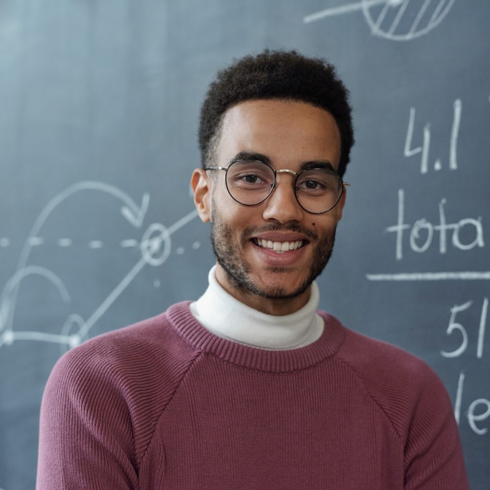 happy young man wearing readers